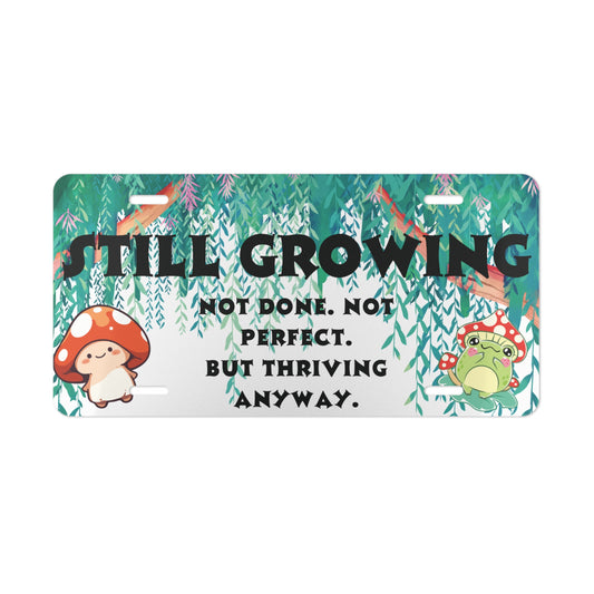 Still Growing Front License Plate – Whimsical Forest Affirmation with Frog & Mushroom Art